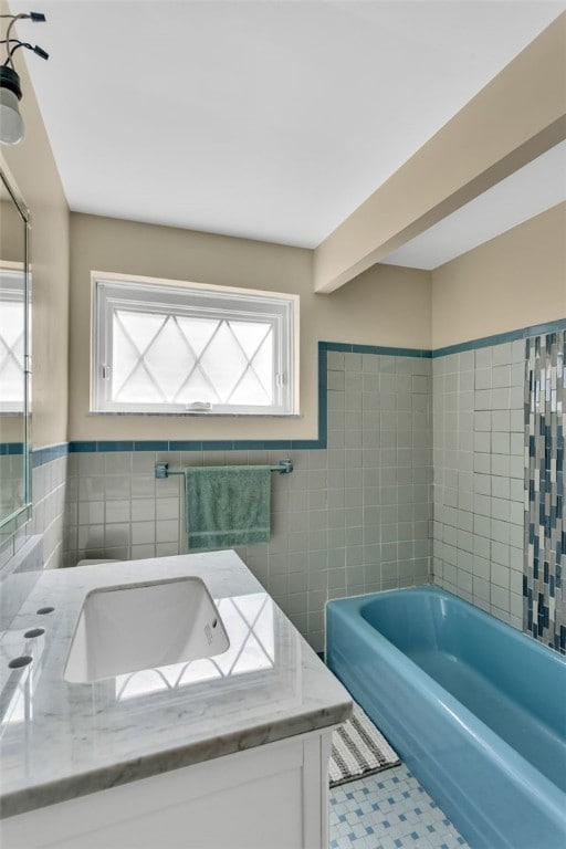 2860 Beaver Rd, Pa, PA 15003 - bathroom featuring tile walls, a bathtub, vanity, and a wainscoted wall