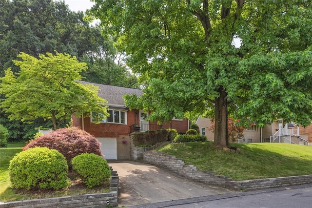 2860 Beaver Rd, Pa, PA 15003 - obstructed view of property featuring concrete driveway, a garage, roof with shingles, a front yard, and brick siding