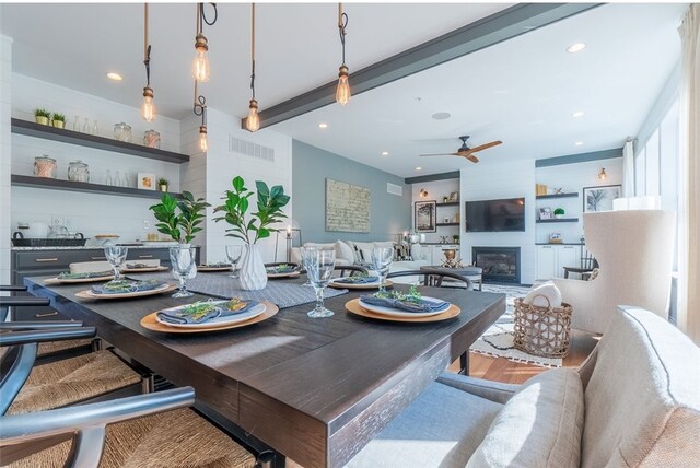 421 Johnston Rd, Saint Clair, PA 15241 - dining area featuring a ceiling fan, recessed lighting, a glass covered fireplace, beamed ceiling, and wood finished floors