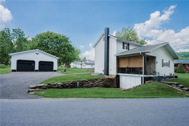 68 Riverside Ave, Center Twp/Homer Cty, PA 15748 - view of side of property with a detached garage, an outdoor structure, a yard, and a chimney