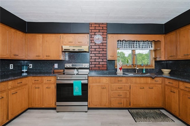 68 Riverside Ave, Center Twp/Homer Cty, PA 15748 - kitchen with stainless steel electric range, under cabinet range hood, tasteful backsplash, light wood-type flooring, and dark stone counters