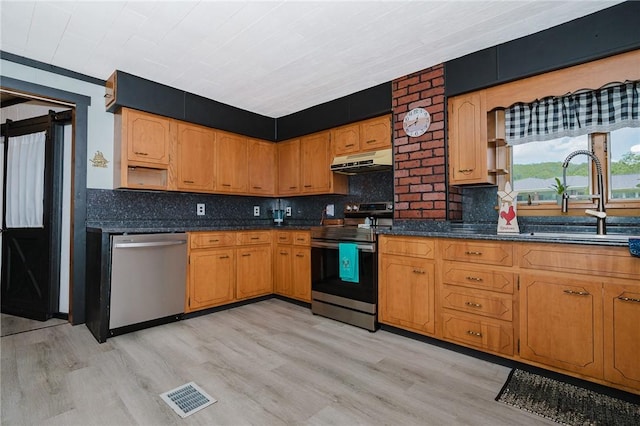 68 Riverside Ave, Center Twp/Homer Cty, PA 15748 - kitchen featuring appliances with stainless steel finishes, under cabinet range hood, light wood-style flooring, backsplash, and brown cabinets