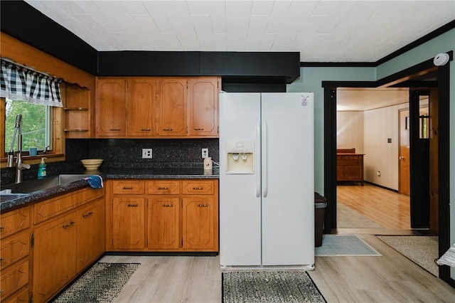 68 Riverside Ave, Center Twp/Homer Cty, PA 15748 - kitchen featuring white fridge with ice dispenser, light wood finished floors, brown cabinets, open shelves, and crown molding