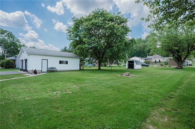 68 Riverside Ave, Center Twp/Homer Cty, PA 15748 - view of grassy yard with an outbuilding, a garage, and driveway