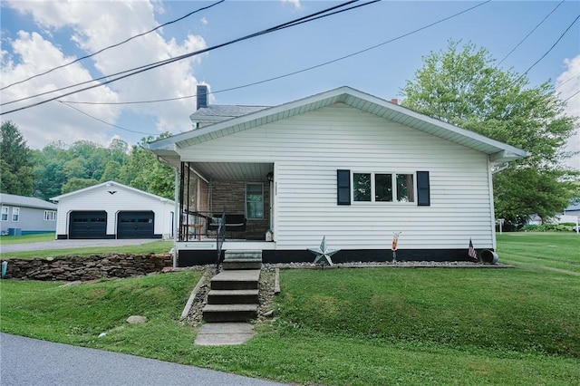 68 Riverside Ave, Center Twp/Homer Cty, PA 15748 - view of front of property with a porch, a garage, a front yard, and an outbuilding