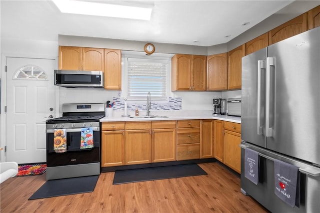 1434 Washington Blvd, Port Vue, PA 15133 - kitchen with appliances with stainless steel finishes, light countertops, and light wood-type flooring