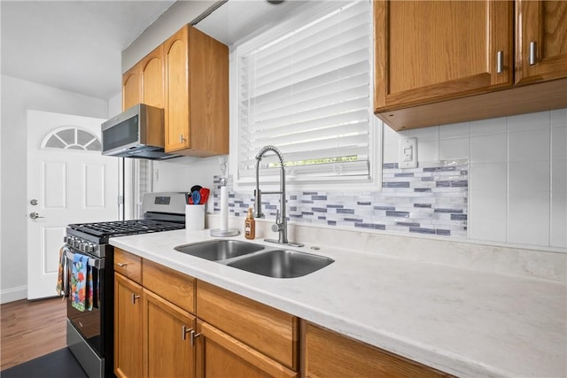 1434 Washington Blvd, Port Vue, PA 15133 - kitchen featuring appliances with stainless steel finishes, light countertops, backsplash, dark wood-style flooring, and brown cabinets