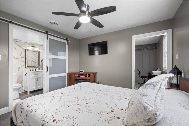 1434 Washington Blvd, Port Vue, PA 15133 - bedroom with a barn door, dark wood-style flooring, ensuite bathroom, and a ceiling fan
