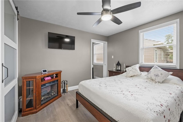 1434 Washington Blvd, Port Vue, PA 15133 - bedroom featuring wood finished floors, ceiling fan, and a barn door