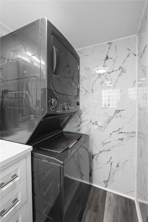 1434 Washington Blvd, Port Vue, PA 15133 - washroom with stacked washing machine and dryer and wood finished floors