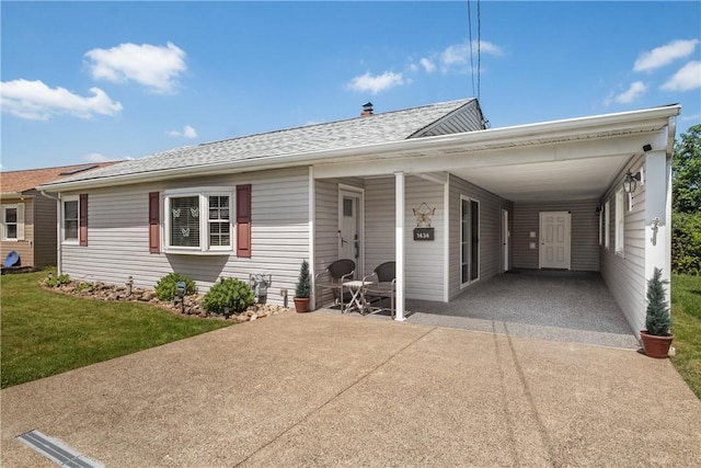 1434 Washington Blvd, Port Vue, PA 15133 - view of front of home featuring driveway, an attached carport, a front yard, and a shingled roof