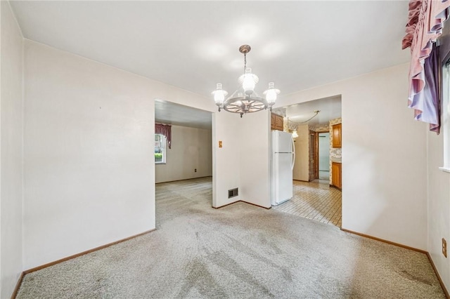 172 Fox Chase Dr, Penn Hills, PA 15147 - spare room featuring light carpet and a chandelier
