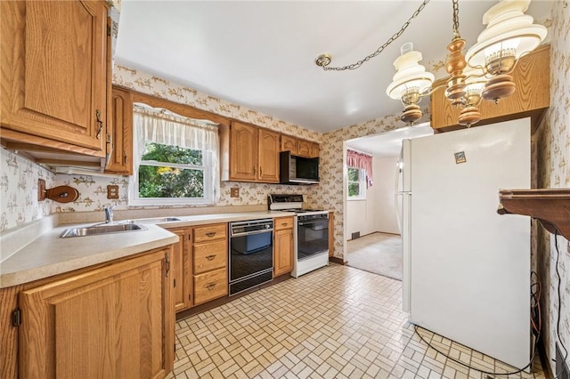 172 Fox Chase Dr, Penn Hills, PA 15147 - kitchen featuring black appliances, wallpapered walls, light countertops, brick patterned floors, and brown cabinetry