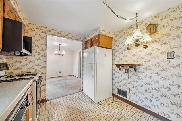 172 Fox Chase Dr, Penn Hills, PA 15147 - kitchen featuring white appliances, a chandelier, wallpapered walls, brown cabinets, and hanging light fixtures