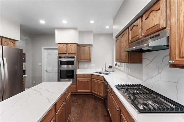 3013 Chessman St, Hampton, PA 15101 - kitchen with under cabinet range hood, stainless steel appliances, dark wood finished floors, light stone counters, and decorative backsplash