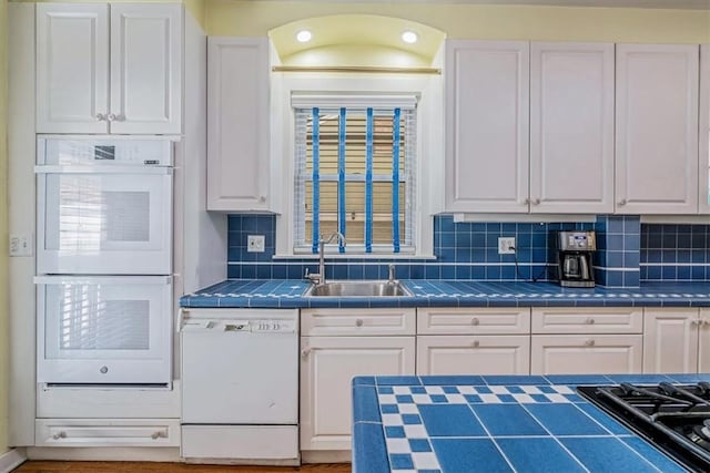 6403 Beacon St, Squirrel Hill, PA 15217 - kitchen featuring white appliances, white cabinetry, tile counters, and decorative backsplash
