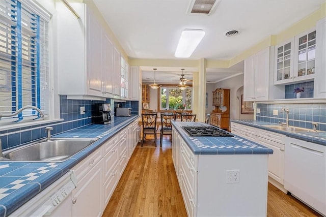 6403 Beacon St, Squirrel Hill, PA 15217 - kitchen featuring tile counters, dishwasher, gas cooktop, and white cabinetry