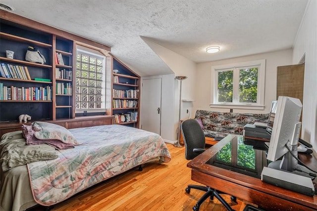 6403 Beacon St, Squirrel Hill, PA 15217 - bedroom featuring a textured ceiling, wood finished floors, lofted ceiling, and multiple windows