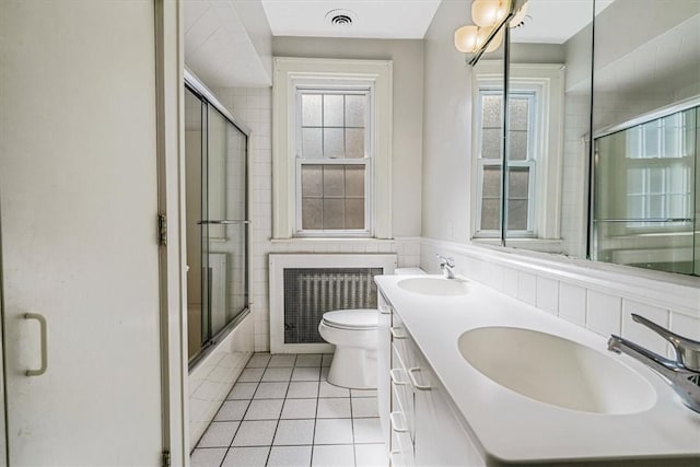 6403 Beacon St, Squirrel Hill, PA 15217 - full bathroom featuring tile patterned flooring, radiator heating unit, double vanity, healthy amount of natural light, and wainscoting