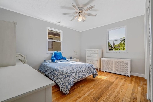 6403 Beacon St, Squirrel Hill, PA 15217 - bedroom featuring radiator, light wood-type flooring, ceiling fan, and ornamental molding