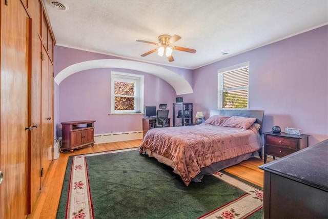 6403 Beacon St, Squirrel Hill, PA 15217 - bedroom with ornamental molding, light wood-style flooring, a baseboard heating unit, ceiling fan, and arched walkways
