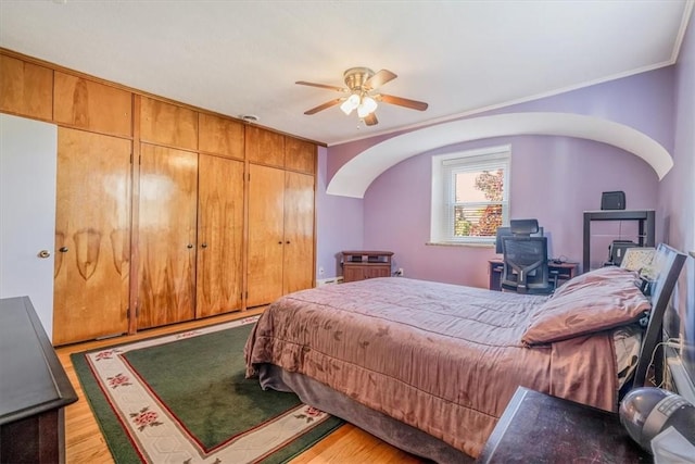 6403 Beacon St, Squirrel Hill, PA 15217 - bedroom featuring wood finished floors, arched walkways, a wood stove, a closet, and a ceiling fan