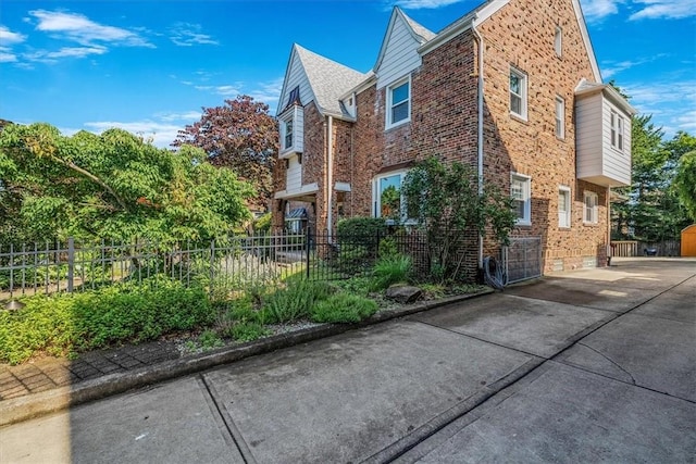 6403 Beacon St, Squirrel Hill, PA 15217 - view of side of home featuring brick siding, driveway, and a patio area