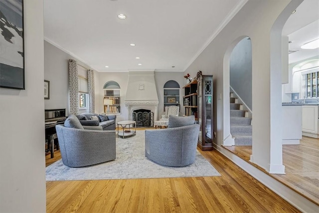 6403 Beacon St, Squirrel Hill, PA 15217 - living room featuring plenty of natural light, ornamental molding, wood finished floors, stairway, and a fireplace