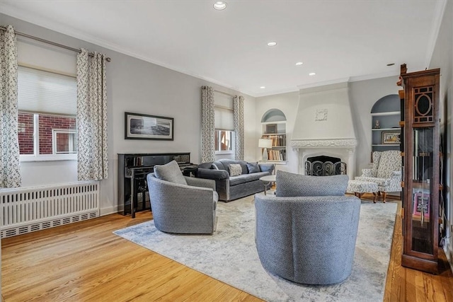 6403 Beacon St, Squirrel Hill, PA 15217 - living area with radiator, wood finished floors, crown molding, a large fireplace, and built in features