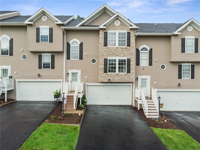 1120 Arrowhead Dr, South Strabane, PA 15301 - view of front of house with stone siding, asphalt driveway, and an attached garage