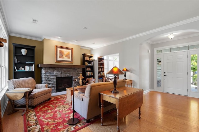 517 Altmyer Fields Ln, Marshall, PA 15090 - living room with arched walkways, plenty of natural light, a stone fireplace, light wood-style flooring, and ornamental molding