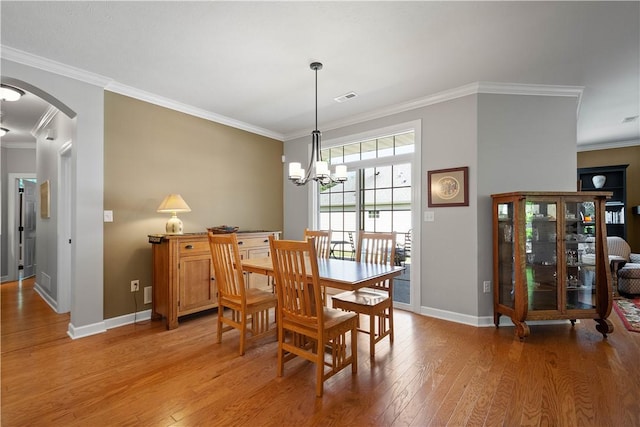 517 Altmyer Fields Ln, Marshall, PA 15090 - dining room with light wood-type flooring, arched walkways, crown molding, and a chandelier