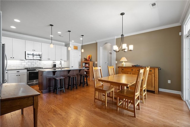 517 Altmyer Fields Ln, Marshall, PA 15090 - dining room featuring light wood-style flooring, ornamental molding, recessed lighting, arched walkways, and a chandelier