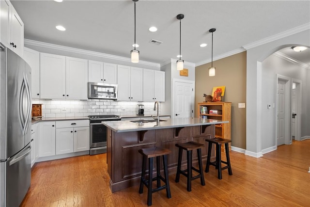 517 Altmyer Fields Ln, Marshall, PA 15090 - kitchen with appliances with stainless steel finishes, crown molding, arched walkways, light wood-style floors, and decorative backsplash