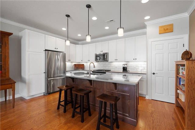 517 Altmyer Fields Ln, Marshall, PA 15090 - kitchen with stainless steel appliances, wood finished floors, a kitchen breakfast bar, crown molding, and tasteful backsplash