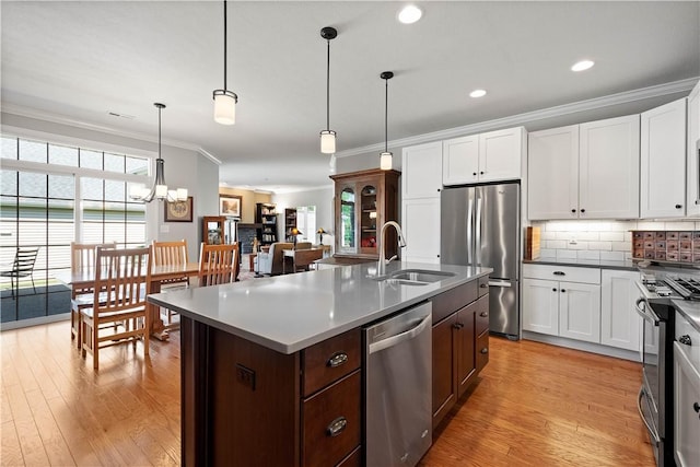 517 Altmyer Fields Ln, Marshall, PA 15090 - kitchen with appliances with stainless steel finishes, ornamental molding, light wood finished floors, tasteful backsplash, and white cabinetry