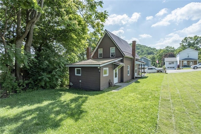 133 2nd, St, PA 15961 - view of home's exterior with a chimney and a yard