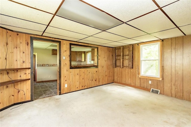 133 2nd, St, PA 15961 - unfurnished room featuring a drop ceiling, wooden walls, and carpet floors