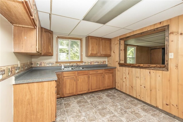 133 2nd, St, PA 15961 - kitchen with a paneled ceiling, plenty of natural light, wood walls, dark countertops, and brown cabinets