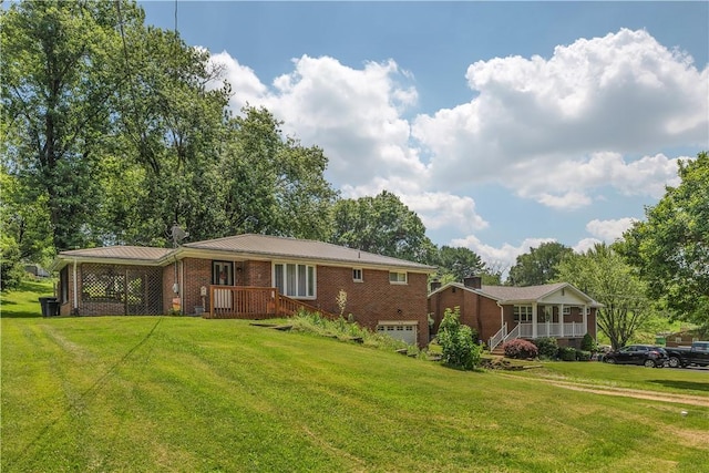 391 Wendel Rd, Pa, PA 15642 - rear view of property featuring brick siding, a lawn, an attached garage, and a metal roof