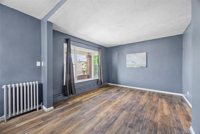 123 Labelle St, Mt Washington, PA 15211 - spare room with radiator heating unit and wood finished floors