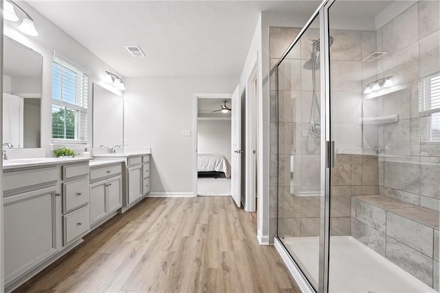 3049 Eagle Ridge Dr, Middlesex Twp, PA 16059 - ensuite bathroom featuring double vanity, wood finished floors, a stall shower, and ceiling fan