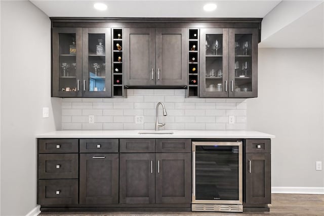 3049 Eagle Ridge Dr, Middlesex Twp, PA 16059 - bar area featuring wine cooler, decorative backsplash, wood finished floors, and recessed lighting