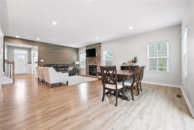 3049 Eagle Ridge Dr, Middlesex Twp, PA 16059 - dining area with a fireplace, light wood-style flooring, recessed lighting, healthy amount of natural light, and stairway