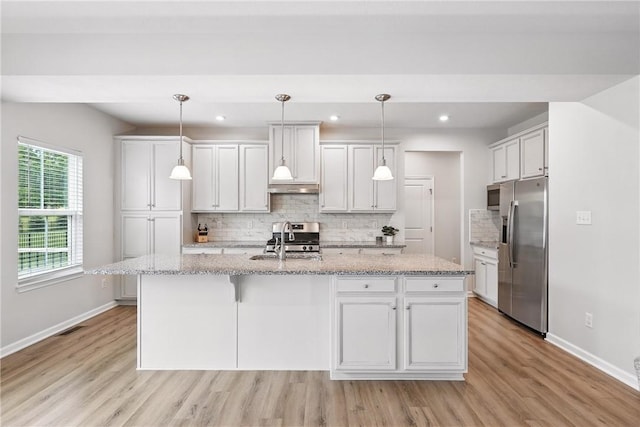 3049 Eagle Ridge Dr, Middlesex Twp, PA 16059 - kitchen with appliances with stainless steel finishes, light wood-style flooring, tasteful backsplash, an island with sink, and recessed lighting