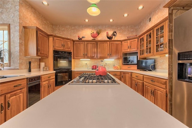410 Lorenzo Ln, Hempfield Twp, PA 15642 - kitchen with stainless steel appliances, light countertops, brown cabinets, and recessed lighting
