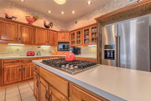 410 Lorenzo Ln, Hempfield Twp, PA 15642 - kitchen with appliances with stainless steel finishes, brown cabinets, light countertops, and recessed lighting
