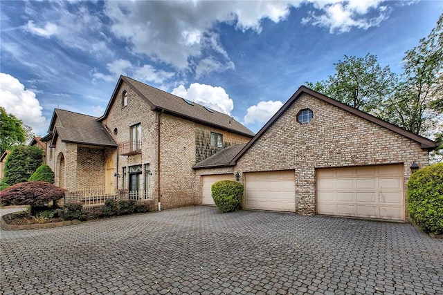 410 Lorenzo Ln, Hempfield Twp, PA 15642 - view of front of property with brick siding, a garage, decorative driveway, and a shingled roof