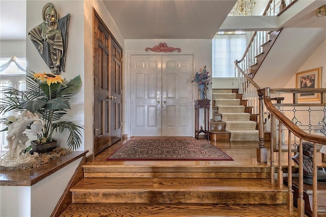 410 Lorenzo Ln, Hempfield Twp, PA 15642 - entrance foyer featuring stairs, healthy amount of natural light, and wood finished floors