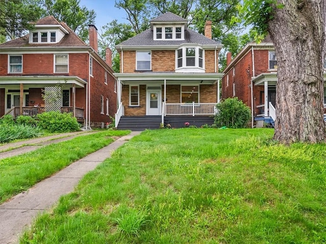 232 Chadwick St, Sewickley, PA 15143 - traditional style home featuring a porch, a chimney, a front lawn, and brick siding